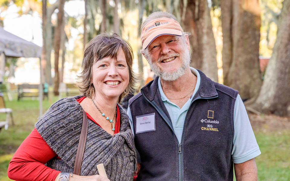 Two guests stop for a photo at Oyster Roast for a Reason.