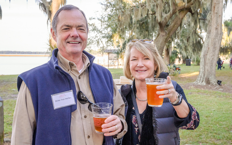 Two guests stop for a photo at Oyster Roast for a Reason.