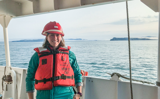Christine Burns is standing on the deck of the NOAA Ship Fairweather as she waits to set out on one of the smaller survey vessels for a day of near shore surveying. Photo credit: Fernando Ortiz.