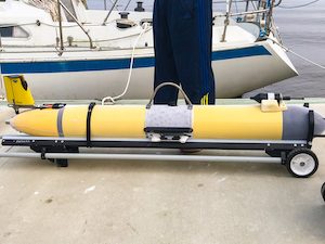 Yellow underwater glider on a dock, about to be put in the water.