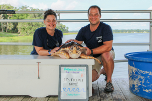 UGA Marine Extension employees Devon Dumont and Lisa Kovalanchik pose with Neptune before she is released
