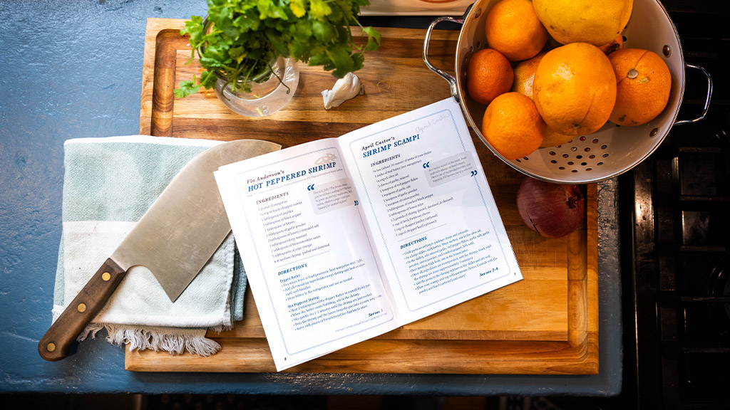 cutting board in a kitchen with a recipe book