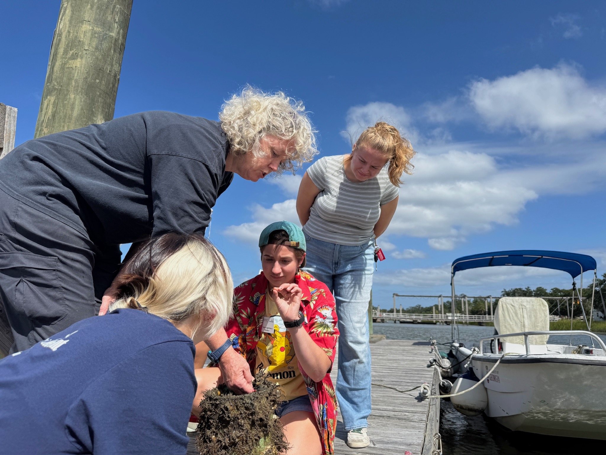 four people on a dock