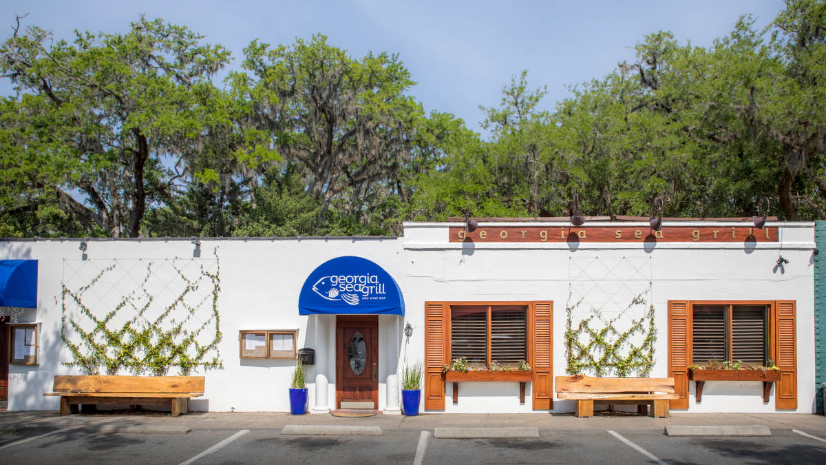 white restuarant building with blue awning